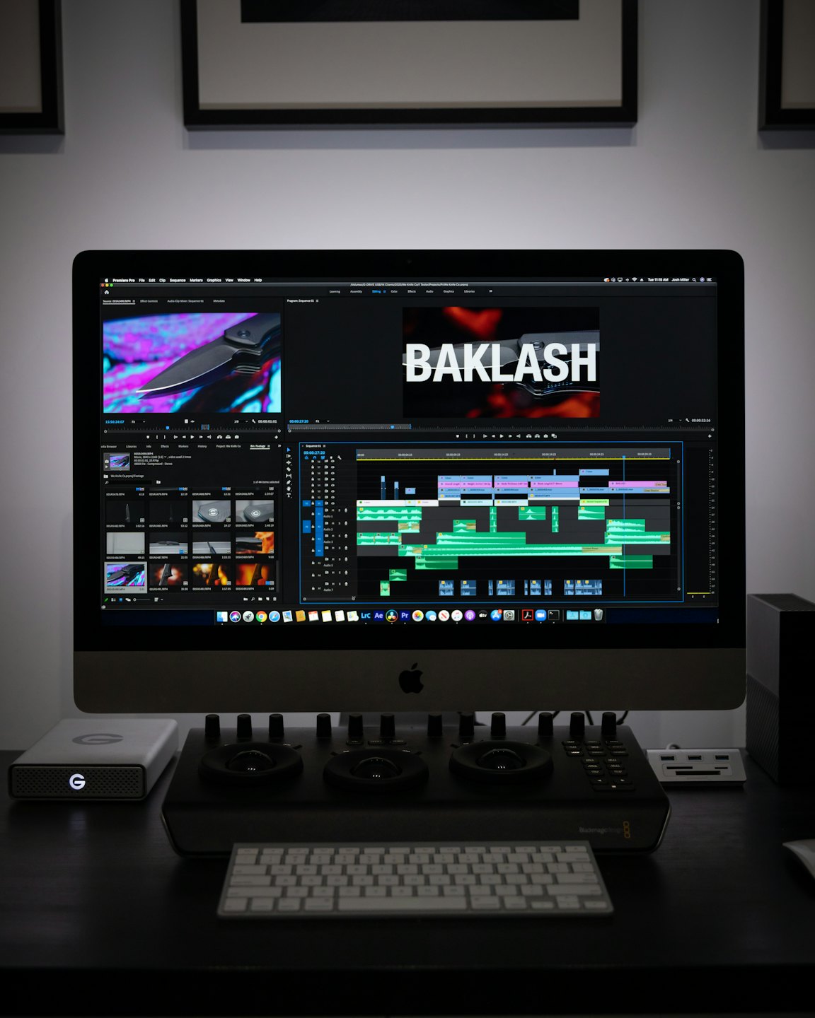 Video editing software on a computer screen with hard drive and control panel.