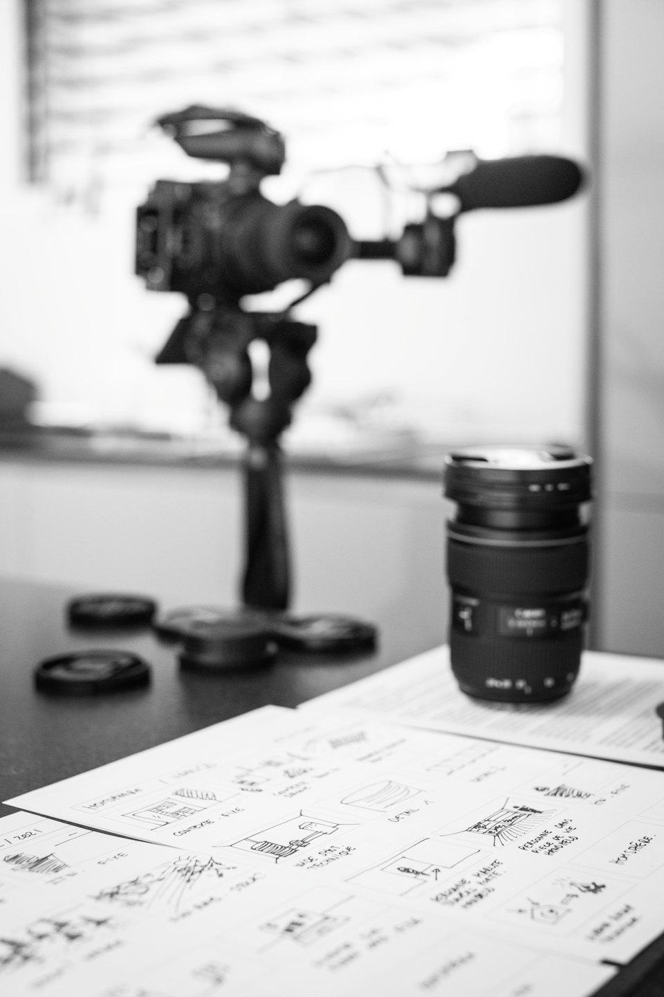 Storyboards and camera lens for video production planning.
