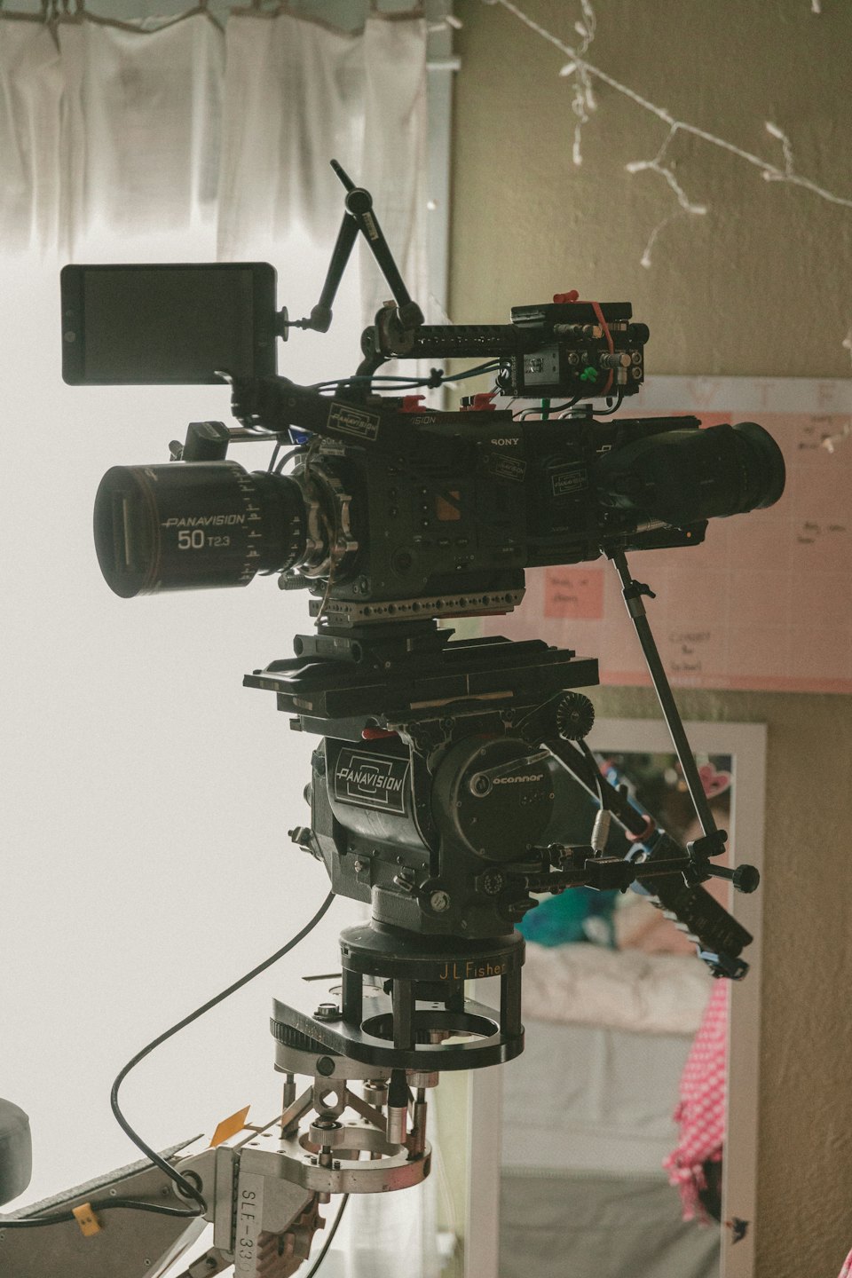 Professional cinema camera mounted on a production tripod.